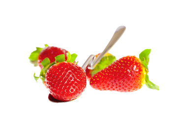 strawberries and spoon isolated on white