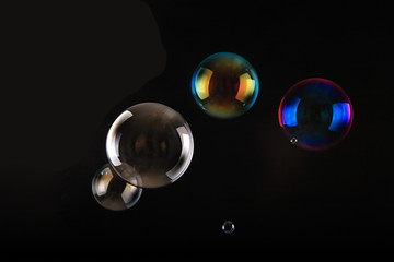 Soap bubbles on black background .