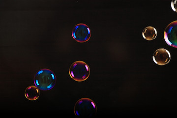Soap bubbles on black background .