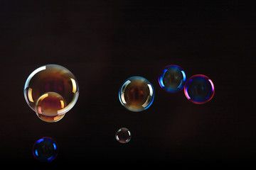 Soap bubbles on black background .