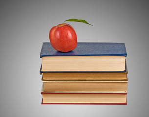 Red apple on pile of books