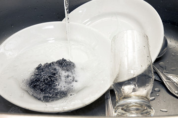 plates and glass washing in a kitchen sink