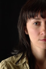 half-portrait of a girl's face in the black background