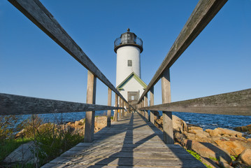 Fototapeta na wymiar Lighthouse at dawn off Anisquam, Massachusetts