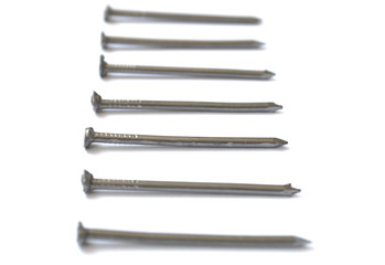 Column of steel nails isolated on white