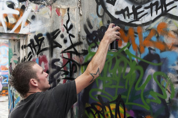 teenage boys tagging painting graffiti