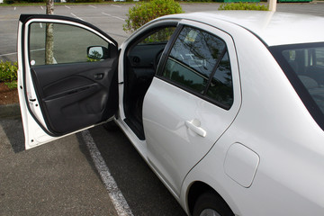 A view of white car front door open.