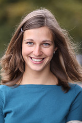 Fototapeta premium Closeup portrait of a happy young woman smiling