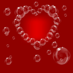 A heart made from soap bubbles on a red background