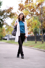 Beautiful young woman in autumn park