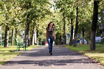 Fototapeta premium Full length, walking woman in blue jeans