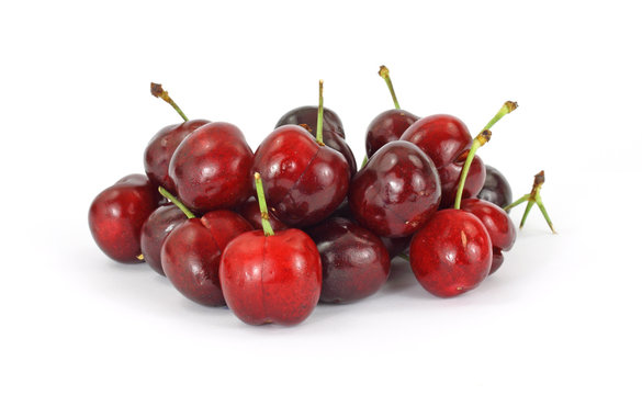 A group of several fresh cherries