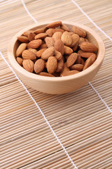 Bowl of almonds on straw serviette