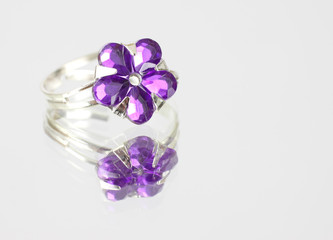 A costume jewelry ring with fake purple stones
