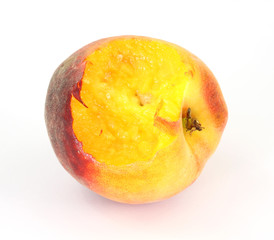Small utility peach that has one bite eaten