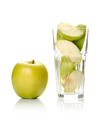 Fototapeta na wymiar Apple and slices in glass isolated on white background