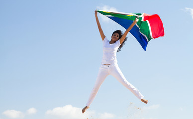 woman jumping holding south african flag
