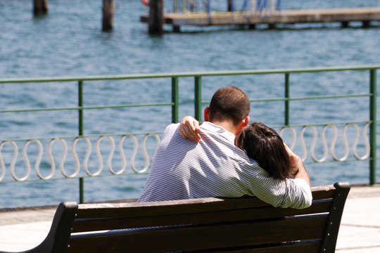 Man and woman embraced each other on a bench