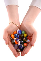 Hands hold glass colour balls