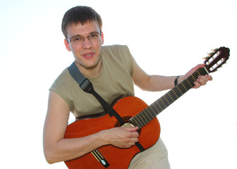 Obraz premium The young man with a guitar against the sky