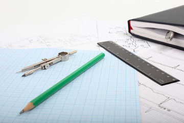 Compass on a graph paper with notepad