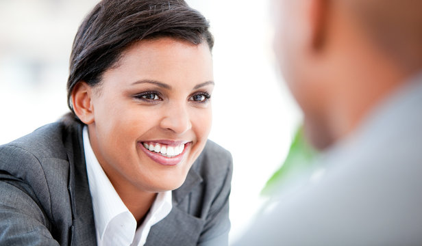 Portrait of a smiling businesswoman talking with her colleague - Powered by Adobe