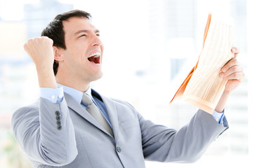 Portrait of a successful businessman reading a newspaper
