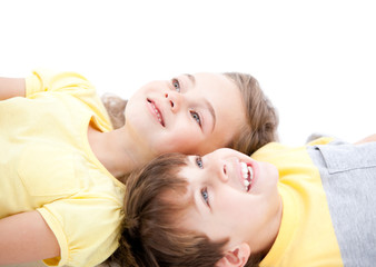 Obraz na płótnie Canvas Smiling childrens lying on the floor together