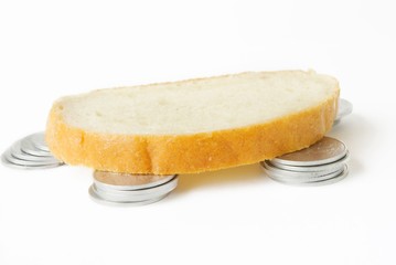 coins and bread over white background