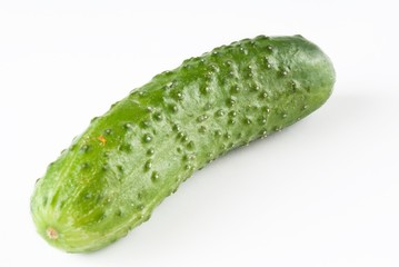 green fresh cucumber over white.