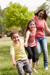 Family of three play in the park