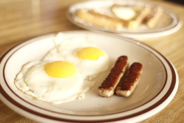 breakfast of french toast, eggs, and sausage