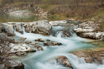 Waterfall with stones in wild nature
