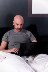 Bald middle aged laptop