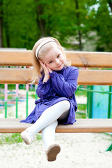 Small girl on a bench