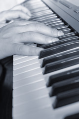 Fototapeta na wymiar Hands above keys of the piano. Monochrome tone