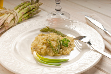 asparagus rice with fork  over dish - riso agli asparagi