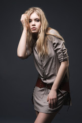 Fototapeta na wymiar Fashion portrait of seductive blond girl on dark background