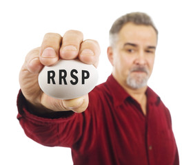 Mature man holds an egg with RRSP on it.