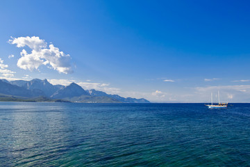Sea, sky, mountains and small ship
