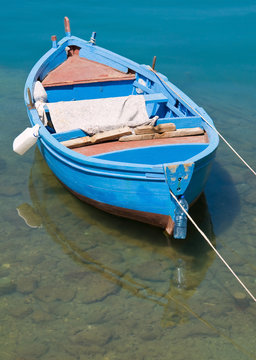 Coloured rowboat in clear sea.