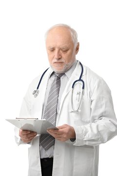 Senior doctor looking at papers