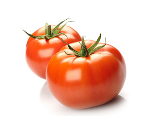 Two tomatoes isolated on white background