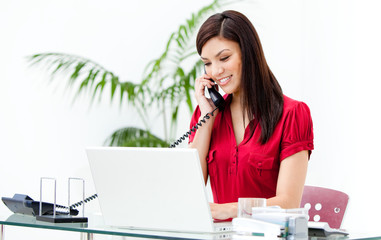 Portrait of a busy businesswoman talking on phone