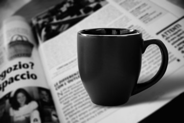 Black cup and newspaper