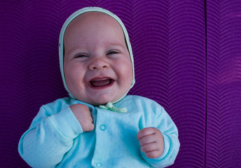 laughing baby on purple background