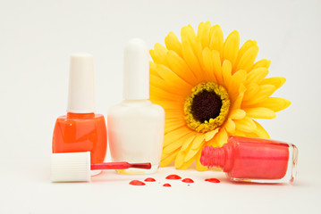 Red and white nailpolish and artificial yellow silk flower