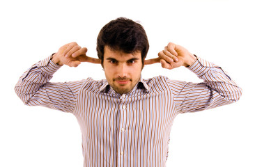 Young man with fingers in ears isolated on white