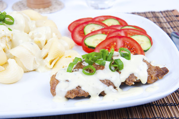Tasty meat with cheese sauce, pastry and vegetable