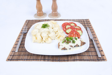 Tasty meat with cheese sauce, pastry and vegetable